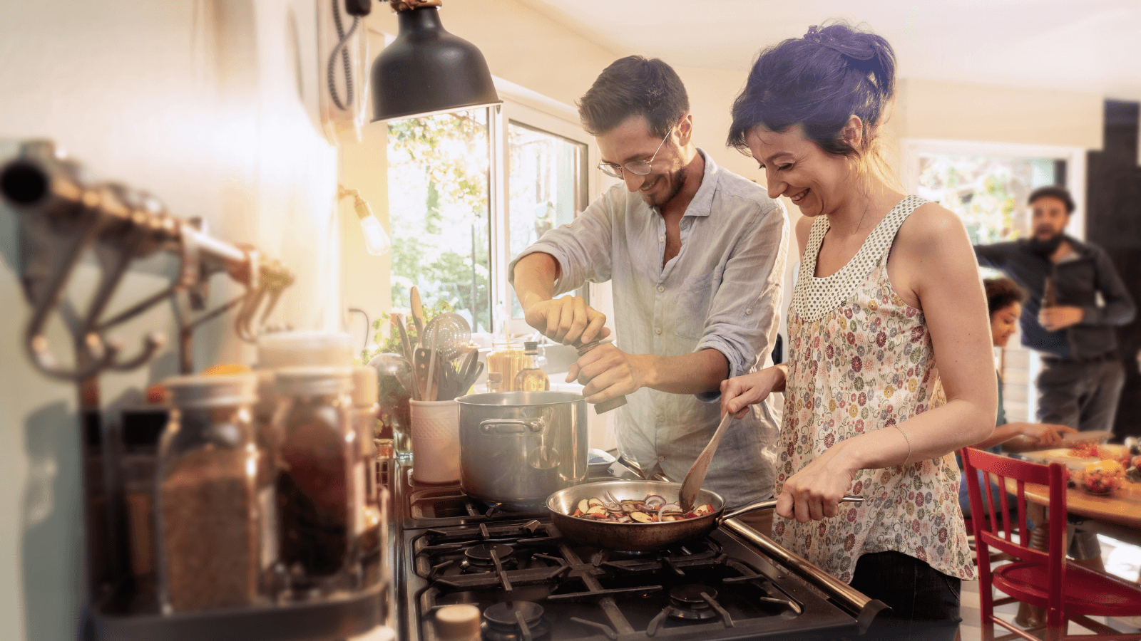 Mixed group of friends have fun while cooking a meal in kitchen