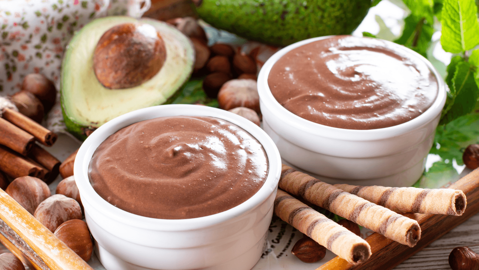 Raw avocado chocolate mousse topped with chocolate and mint. Healthy vegan chocolate dessert.