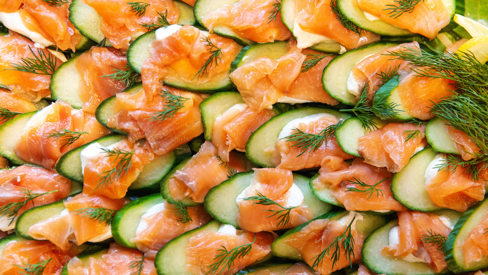 Smoked salmon cucumber bites. keto diet. healthy appetizer background. top view