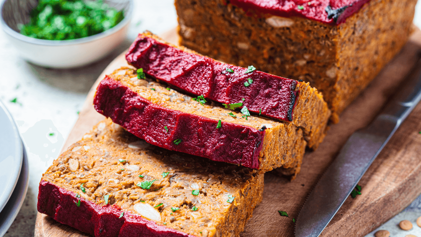 Lentil vegan meat oaf sliced on wooden board. Christmas recipe.