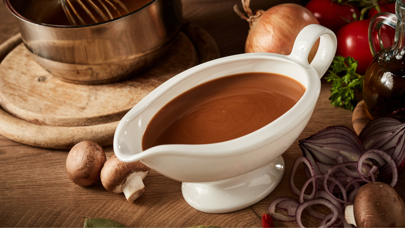 Gravy boat with serving of delicious rich brown sauce or gravy